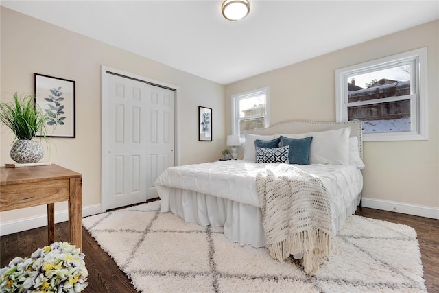 bedroom featuring dark wood-type flooring and a closet