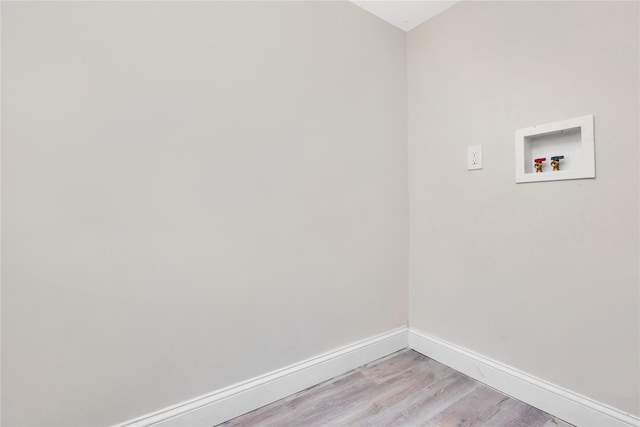 clothes washing area with hookup for a washing machine and light hardwood / wood-style floors