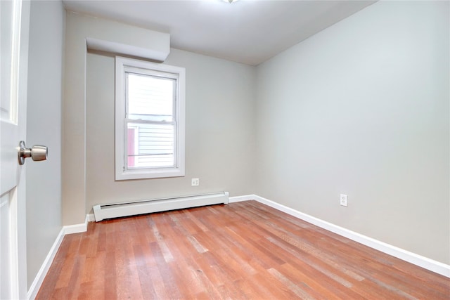 empty room featuring light hardwood / wood-style flooring and a baseboard radiator