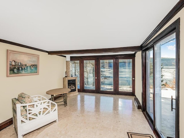 sitting room featuring ornamental molding and french doors