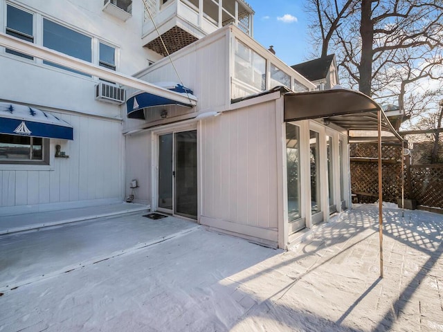 back of house featuring a wall unit AC