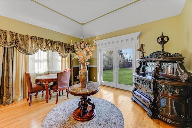 living area with hardwood / wood-style floors and french doors