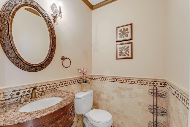 bathroom featuring ornamental molding, tile walls, vanity, and toilet