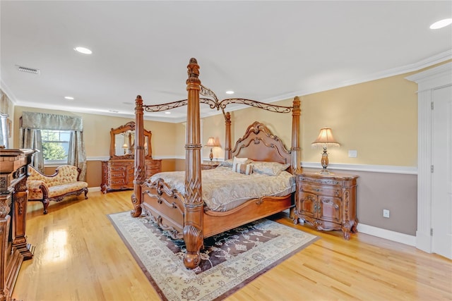 bedroom with crown molding and hardwood / wood-style flooring