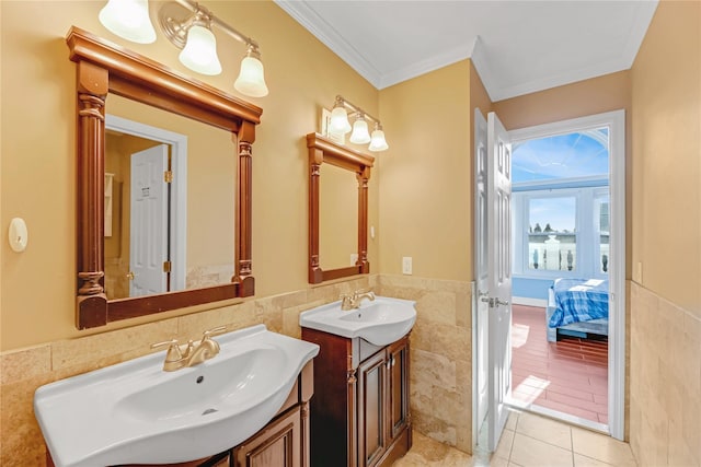 bathroom with tile patterned flooring, vanity, tile walls, and crown molding