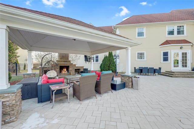 view of patio featuring a gazebo and an outdoor living space with a fireplace