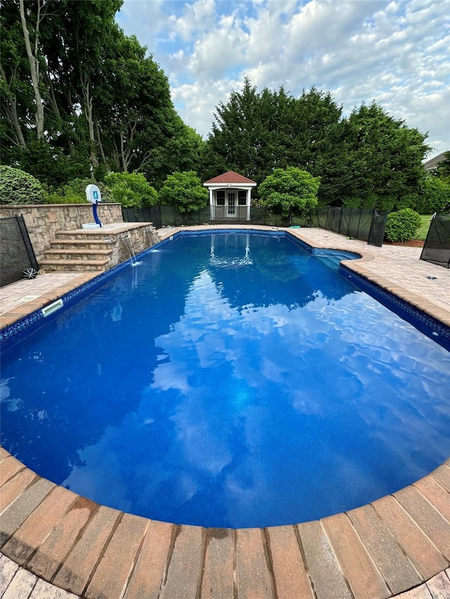 view of swimming pool featuring a gazebo, pool water feature, and a patio