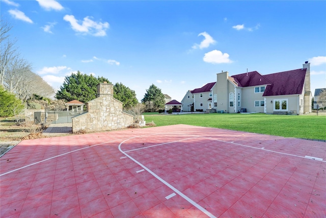 view of basketball court featuring a yard