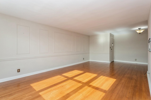 empty room with hardwood / wood-style flooring