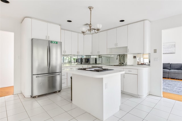 kitchen with sink, white cabinetry, decorative light fixtures, a center island, and stainless steel appliances