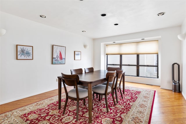 dining space with light hardwood / wood-style flooring