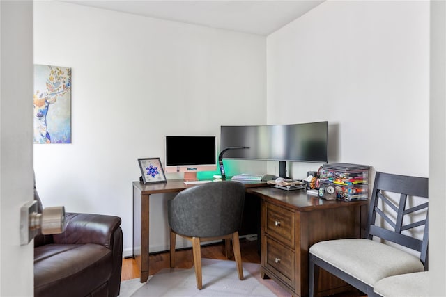 home office with light hardwood / wood-style floors