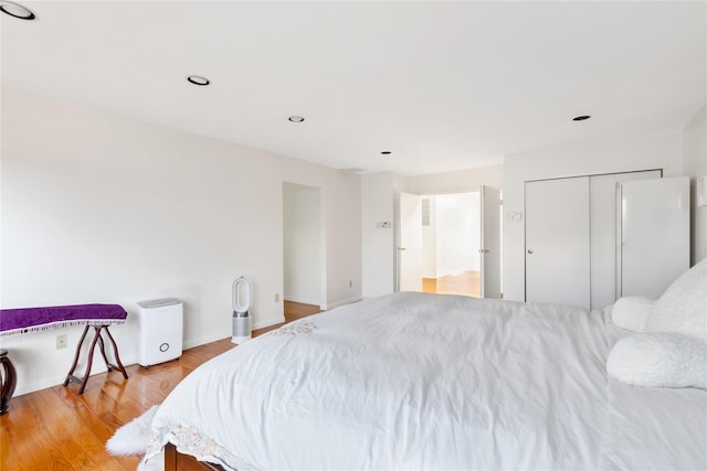 bedroom featuring a closet and light wood-type flooring