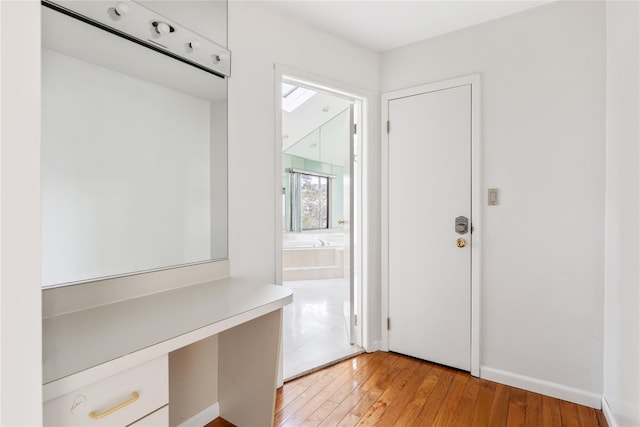 mudroom featuring built in desk and light hardwood / wood-style floors