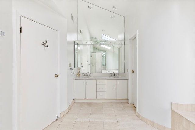 bathroom featuring tile patterned floors, an enclosed shower, and vanity