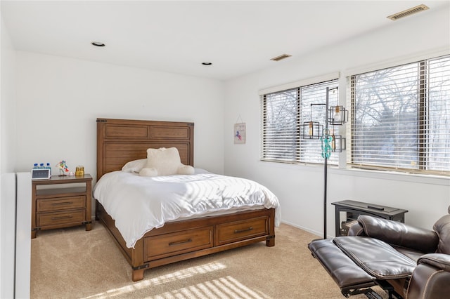 carpeted bedroom with multiple windows