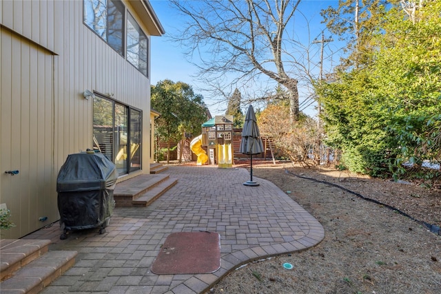 view of patio / terrace with area for grilling and a playground