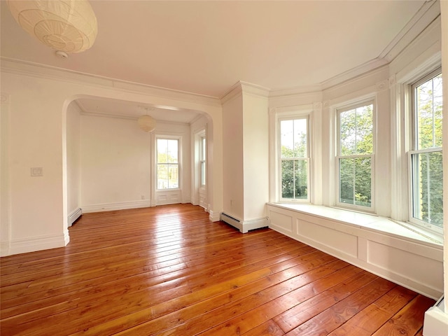 unfurnished room with wood-type flooring, ornamental molding, and baseboard heating