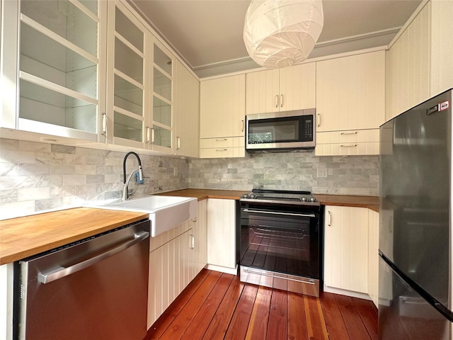 kitchen with tasteful backsplash, sink, dark hardwood / wood-style floors, and appliances with stainless steel finishes