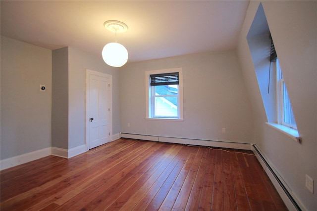 spare room with hardwood / wood-style flooring and a baseboard radiator