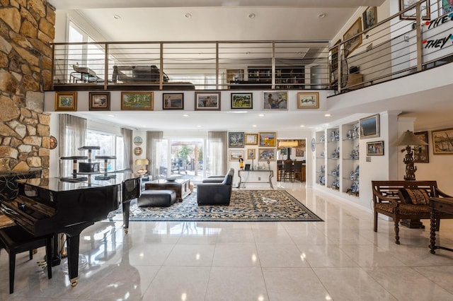 tiled living room featuring a towering ceiling