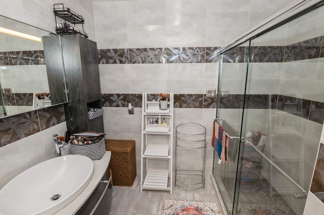 bathroom with vanity, tile walls, and an enclosed shower