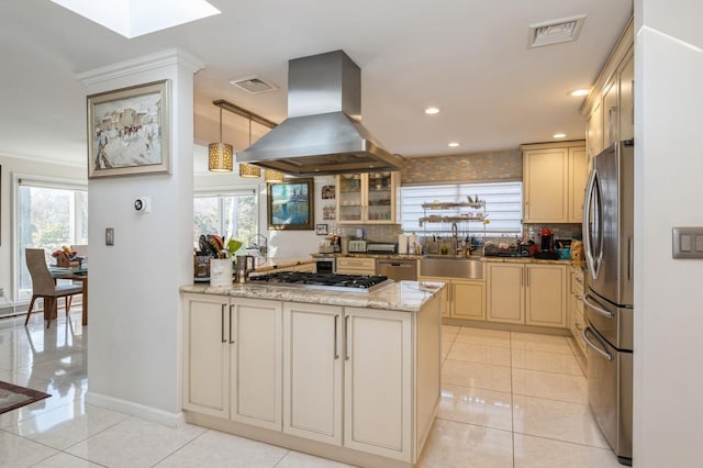 kitchen featuring pendant lighting, sink, stainless steel appliances, light stone counters, and island range hood