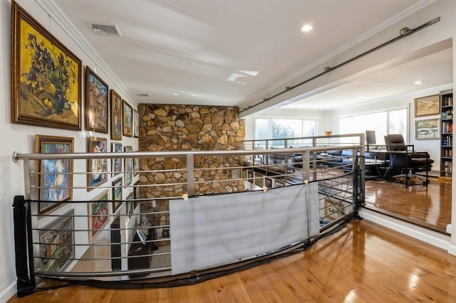 bar with hardwood / wood-style flooring and ornamental molding