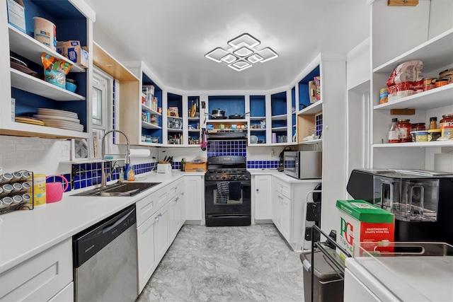 kitchen with white cabinetry, appliances with stainless steel finishes, sink, and backsplash