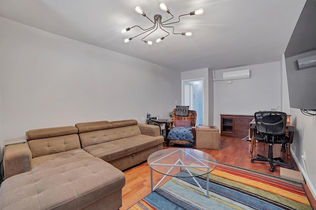 living room featuring an inviting chandelier, hardwood / wood-style floors, and an AC wall unit