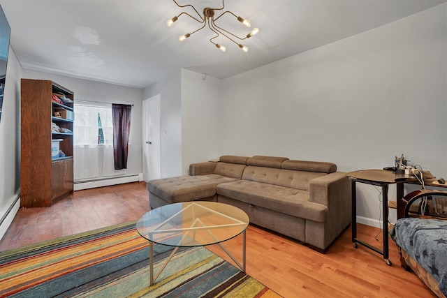 living room featuring hardwood / wood-style flooring, a notable chandelier, and baseboard heating