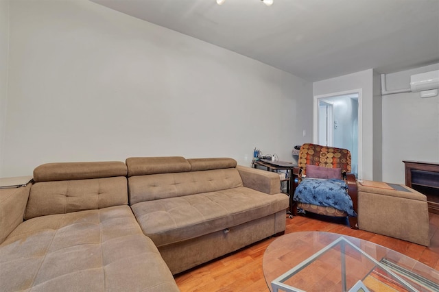 living room with wood-type flooring and a fireplace