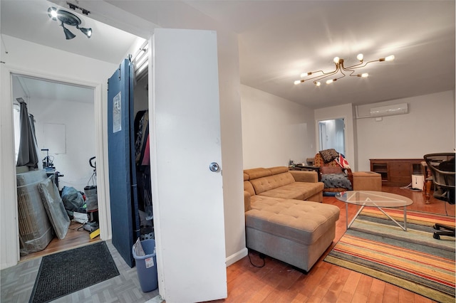 living room with hardwood / wood-style flooring and an AC wall unit