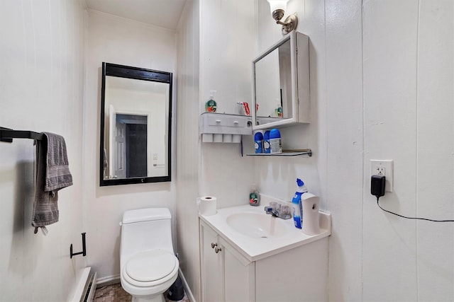 bathroom with vanity, toilet, and baseboard heating