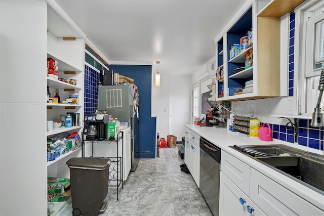 kitchen with decorative light fixtures, sink, white cabinets, decorative backsplash, and stainless steel dishwasher