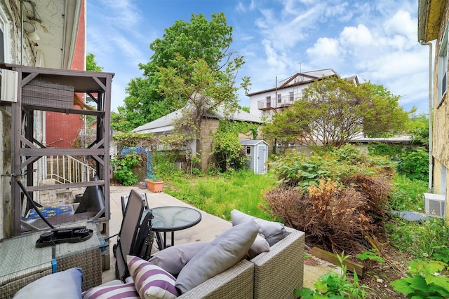 view of patio / terrace featuring outdoor lounge area and a storage shed