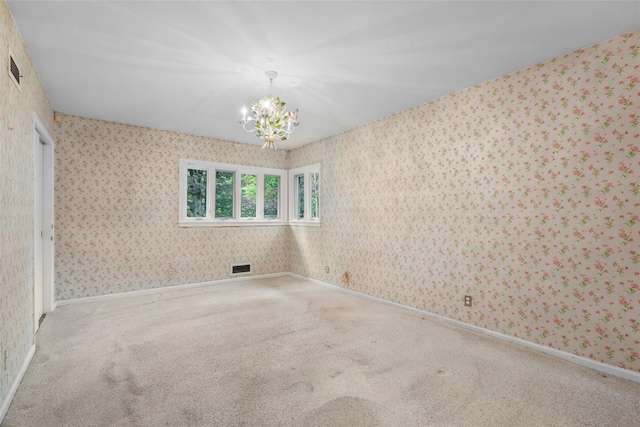 18 Kent Rd, Scarsdale, NY 10583 - carpeted empty room with wallpapered walls and a chandelier