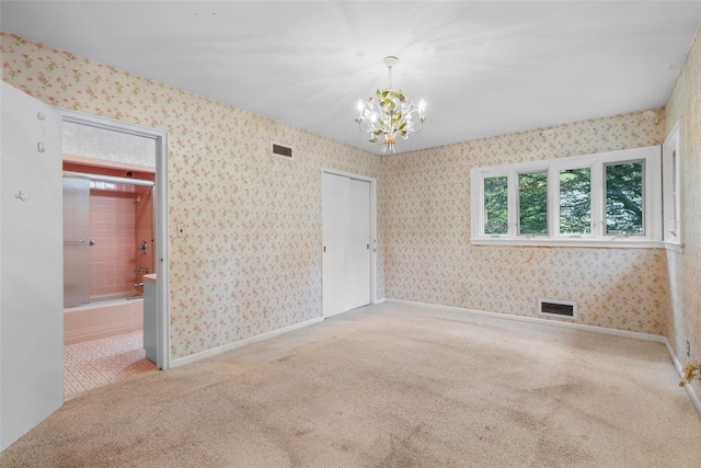 18 Kent Rd, Scarsdale, NY 10583 - unfurnished bedroom with carpet flooring, a chandelier, wallpapered walls, and ensuite bathroom