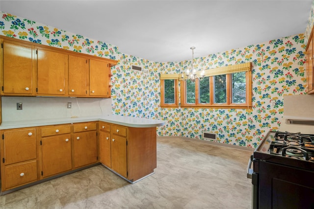 18 Kent Rd, Scarsdale, NY 10583 - kitchen with wallpapered walls, a chandelier, light countertops, a peninsula, and range with gas cooktop
