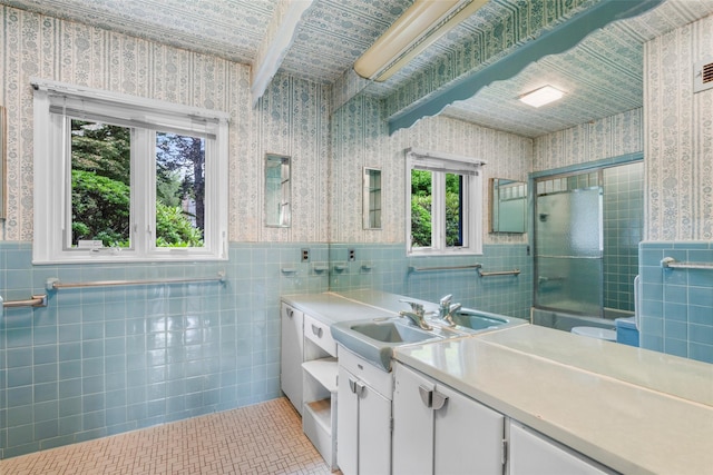 18 Kent Rd, Scarsdale, NY 10583 - full bath with wallpapered walls, tile walls, vanity, a shower with shower door, and tile patterned floors