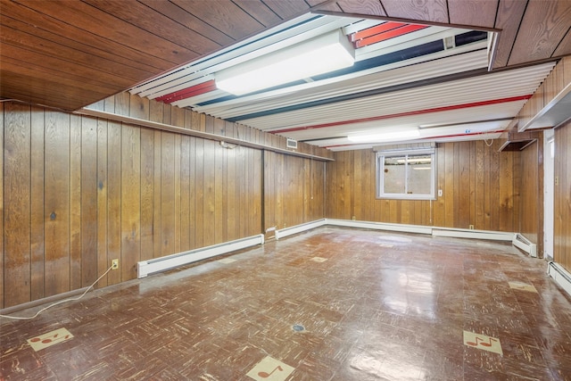 18 Kent Rd, Scarsdale, NY 10583 - basement featuring baseboard heating, tile patterned floors, and wooden walls