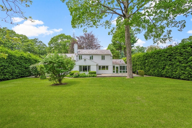 18 Kent Rd, Scarsdale, NY 10583 - rear view of property featuring a lawn, a patio, and a chimney