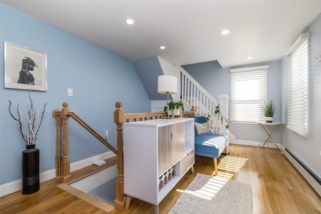 interior space with baseboard heating and light wood-type flooring