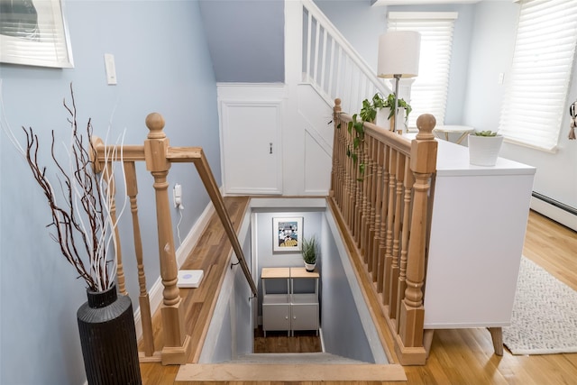 stairs featuring hardwood / wood-style floors