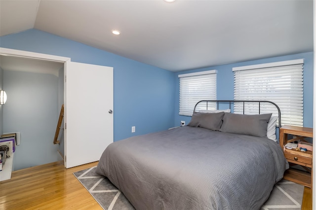 bedroom with light hardwood / wood-style flooring and vaulted ceiling