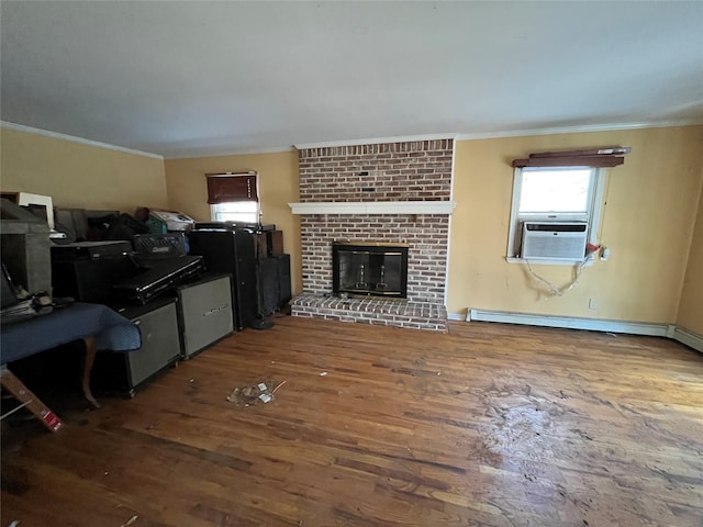 living room featuring hardwood / wood-style flooring, crown molding, a fireplace, and baseboard heating