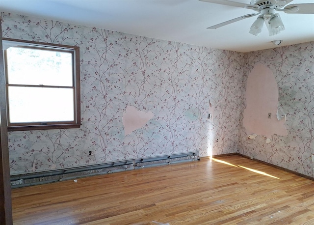 spare room featuring ceiling fan and light hardwood / wood-style floors