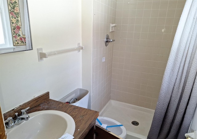 bathroom featuring walk in shower, vanity, and toilet