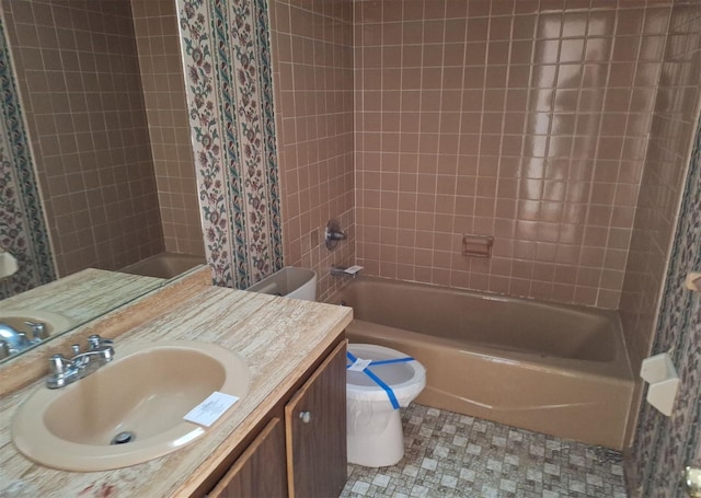 full bathroom with tiled shower / bath combo, vanity, and toilet