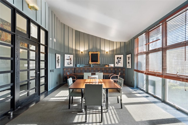 dining room featuring carpet floors, french doors, and a healthy amount of sunlight